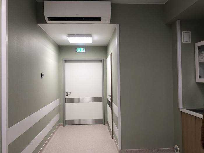The corridor leading to the examination room, with impact-protection wall rails.