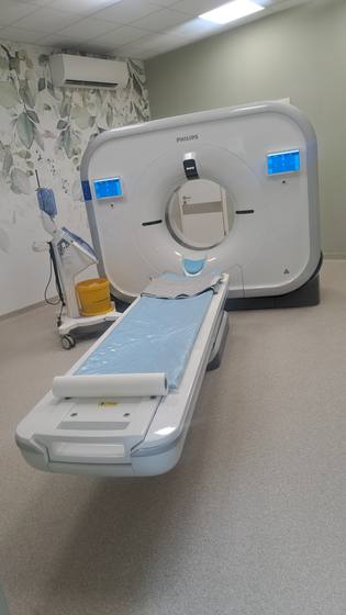 The CT scanner with the patient table in the finished examination room.