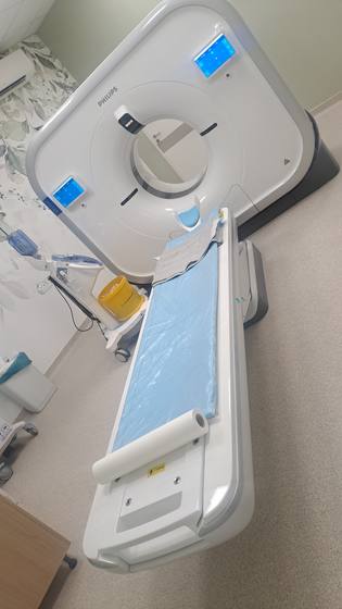 The CT gantry with the patient table.